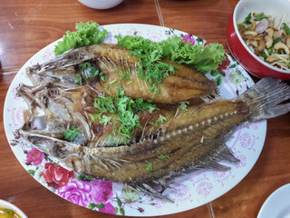 Fried fish in bowl on table.