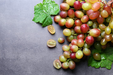 Fresh ripe grapes on textured background