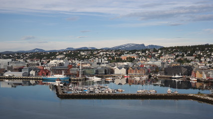 Scenery of Tromso harbor and the city`s nature sorroundings with massive and snowed mountains, Norway