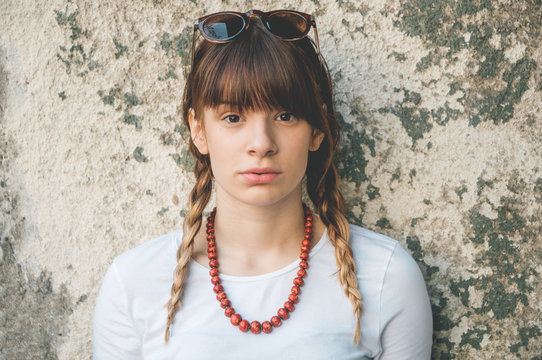 Portrait of young beautiful woman in front of grunge background