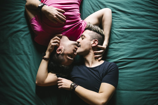 Affectionate gay couple lying together