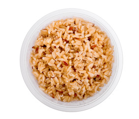 top view of brown rice in plastic cup isolated on white background