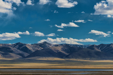 Panoramic view of green plain with hills at sunny day

