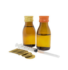 syringe drug opaque glass bottles and stack of coin in budget cost money concept spend to health with clipping path on isolated white background