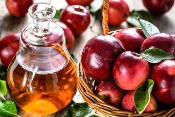 Apple cider vinegar or bottle of alcohol beverage from fresh apples, organic food concept