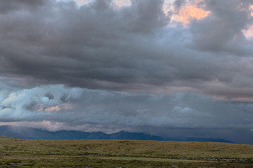 grey clouds in sky over great mountains 
