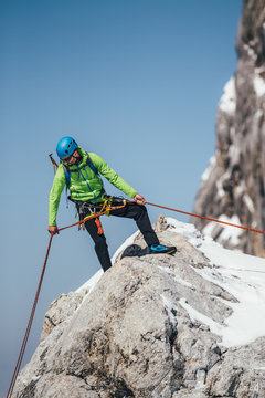 male mountaineer abseiling from austrian glacier