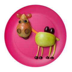 Happy camel made with fruits on pink plate