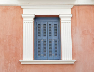 light blue shutters window with white frame