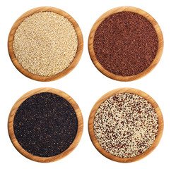Black, red and white quinoa grains on wooden bowl.