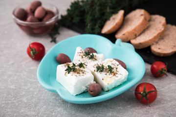 Greek cheese feta with thyme and olives.  selective focus, copy space