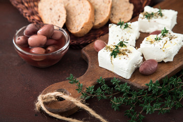 Greek cheese feta with thyme and olives.  selective focus, copy space
