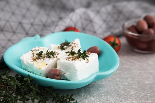 Greek cheese feta with thyme and olives.  selective focus, copy space