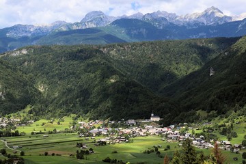 Fototapeta na wymiar Village Srednja vas in Slovenia with Julian alps in background