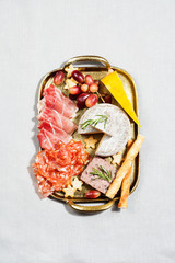 Food tray with charcuterie assortment, cheese  and grapes