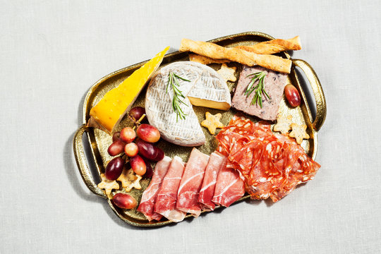 Food tray with charcuterie assortment, cheese  and grapes