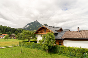 Plakat village houses in a mountain Alps landscape