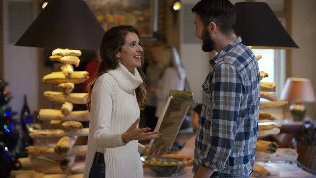 Happy couple at Xmas, man giving his partner a gift