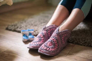 Children's blue white booties and women's legs.