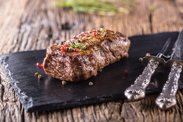 Beef Steak. Roasted Beef steak with salt pepper thyme on rustic wooden table