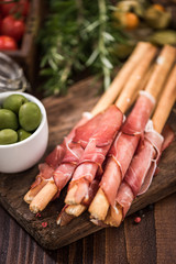Bread sticks with prosciutto ham,italian tapa food