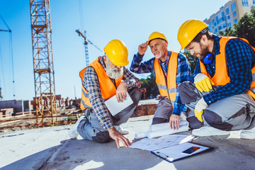 construction workers with building plans
