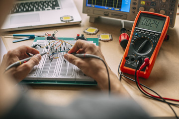 Engineer Testing Electronic Equipment at Home