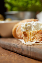 Cheese, vegetables, fruits and spices. Bread, olives and crackers. Mediterranean diet and cuisine. Dark background.