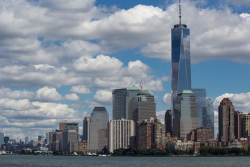Urban New York American  landscape from ocean (among water) with skyscrapers and blue sky with contrast clouds on background
