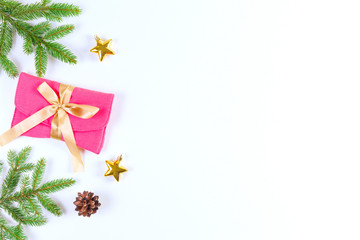 Christmas background with fir branches, pine cones, Xmas present and decoration on white background.
