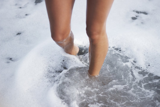Woman's legs in clear sea water