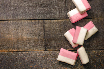 Pink marshmallows on a dark background with copyspace