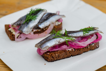 Sandwich with tulle, pickled onion and rye bread. Street food, food festival.