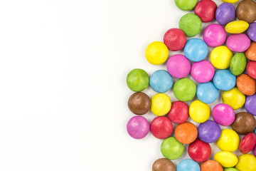 background of multicolored sugar coated candies with copyspace