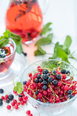 Fresh red and black currant in glass vase