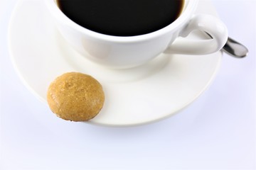 An image of a coffee with a cookie