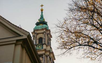 Fototapeta na wymiar beautiful church with autumn tree on the side