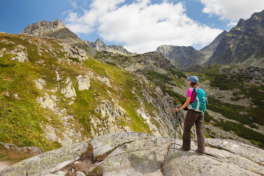Hiking woman admiring the beauty of rocky Tatra mountains