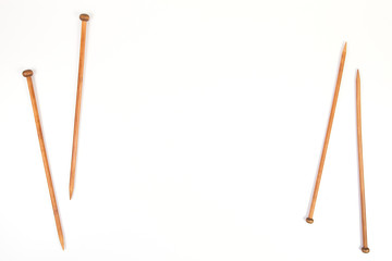 Wooden knitting needles on white background
