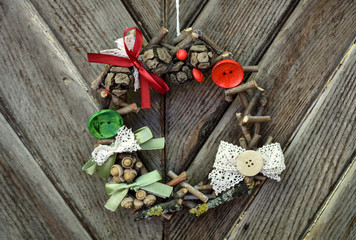 Handmade Christmas ornament hanging on the rope on the rustic wooden background