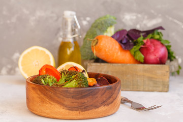 Vegetarian salad of baked vegetables in a wooden bowl