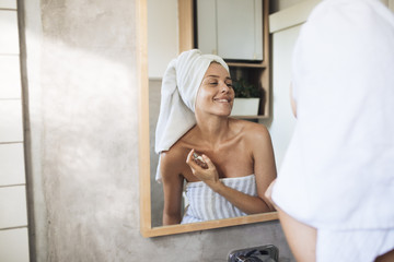 Woman Putting Perfume On