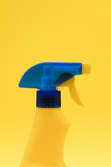 Cleaning spray bottle products on a bright yellow background