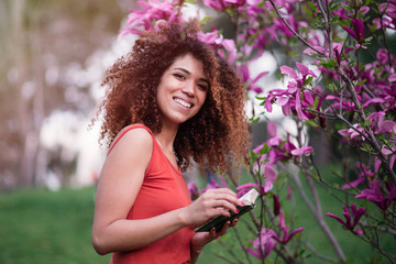 cheerful afro woman holding a book