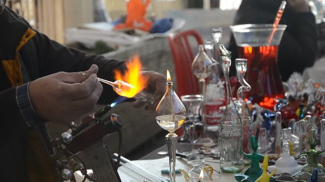 Glassworks glass manufacturing process - glass rolling on the marver