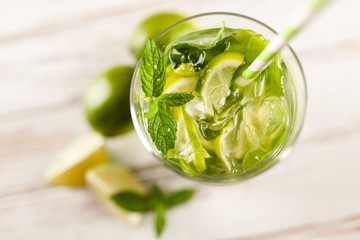 Mojito cocktail on white wood background