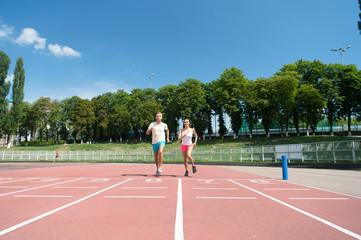 Fototapeta premium Man and woman sunny outdoor on blue sky.