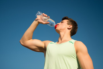 Man drinking water from bottle on sunny day