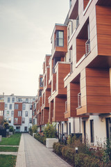 high format picture of modern apartment complex with green park