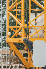 Fototapeta premium Scaffold of a yellow crane on construction site